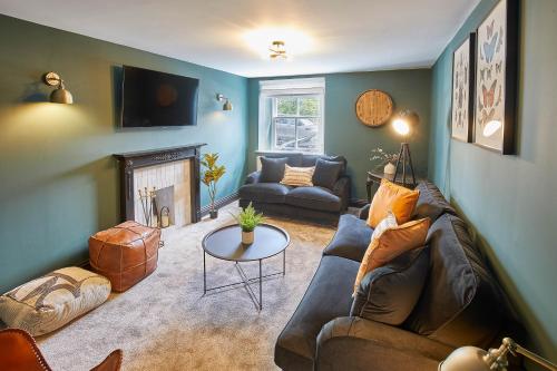 a living room with a couch and a fireplace at Host & Stay - The Old Brewery in Richmond