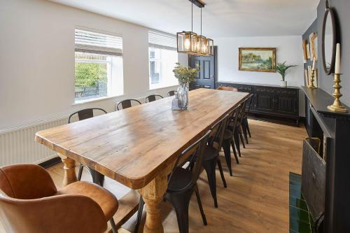 a dining room with a wooden table and chairs at Host & Stay - The Old Brewery in Richmond