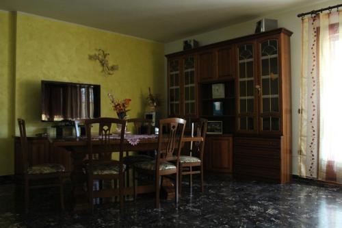 a dining room with a table and chairs at CASA VACANZE “ LA TERRAZZA “ in Comacchio