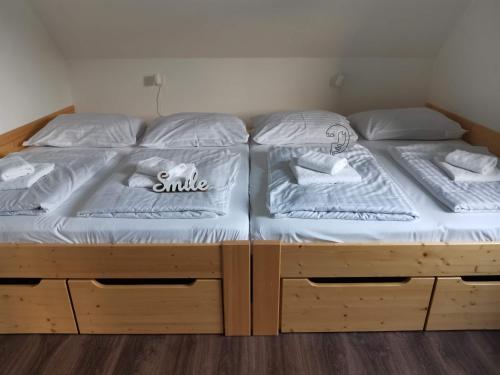 two twin beds in a room with woodenunks at Apartmány Černý vlk, Borová Lada in Borová Lada