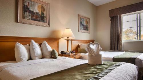 a hotel room with two beds and a window at Best Western Plus Newport News in Newport News