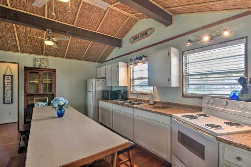 a large kitchen with white appliances and a table at Walk to Ocean Coastal Surfside Beach Bungalow! in Freeport