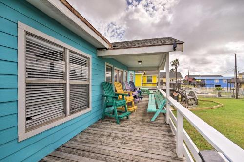 a blue house with rocking chairs on a deck at Walk to Ocean Coastal Surfside Beach Bungalow! in Freeport