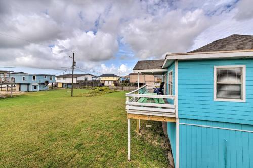 a blue house with a porch and a yard at Walk to Ocean Coastal Surfside Beach Bungalow! in Freeport