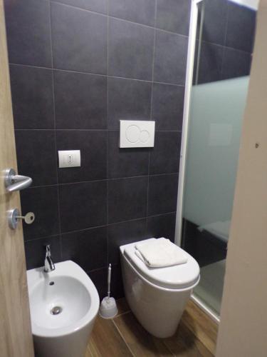 a bathroom with a toilet and a sink and a shower at Hotel Nord Est in Riccione