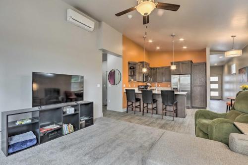 a living room with a couch and a kitchen at Modern Coeur dAlene Home Near Trails and River! in Coeur d'Alene