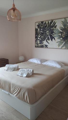 a white bed with two pillows on it in a bedroom at Authentic Charm Soltroia in Troia