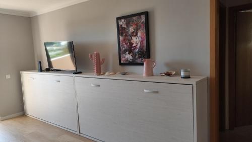 a white dresser with a mirror on top of it at Authentic Charm Soltroia in Troia