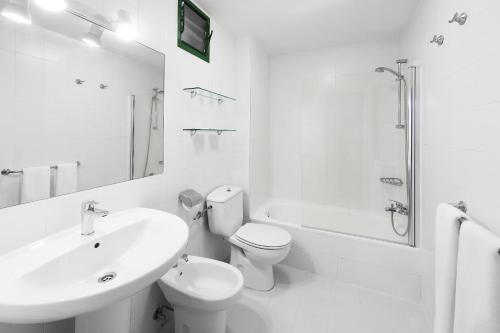 a white bathroom with a sink and a toilet and a shower at Elba Lucía Sport & Suite Hotel in Costa de Antigua