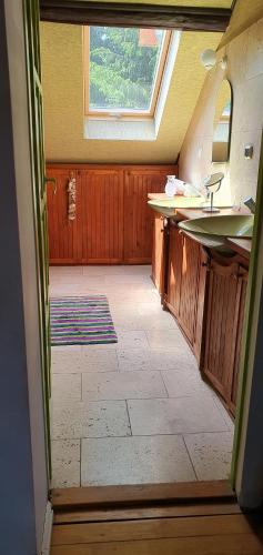 an empty bathroom with two sinks and a window at Stawy Karłowo in Karłowo