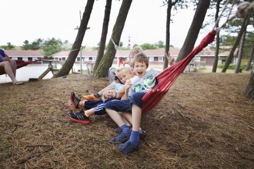 a group of children sitting in a hammock at Sier aan Zee in Hollum