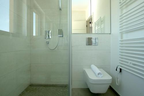 a bathroom with a toilet and a glass shower at The View Luxury Residence with Pool in Zadar