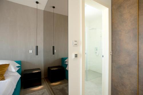 a bedroom with a glass door leading to a shower at The View Luxury Residence with Pool in Zadar