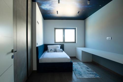 a small bedroom with a bed and a window at The View Luxury Residence with Pool in Zadar