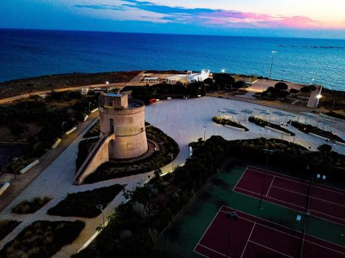 an aerial view of a tennis court next to the ocean at Sirenetta in Torre Suda