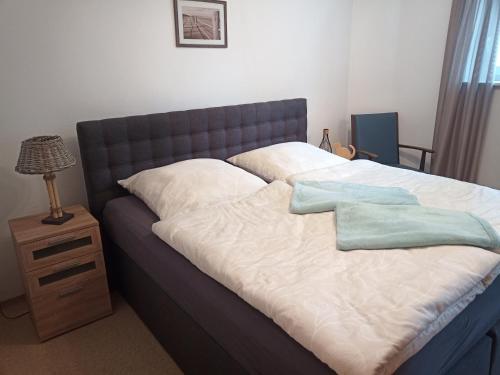 a bed with two pillows on top of it at Ferienwohnung Altmüüültal in Berching