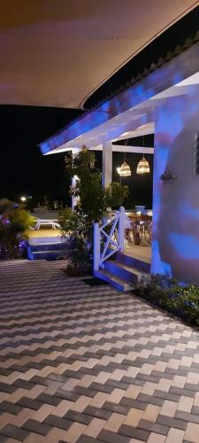 a house with blue lights on the side of it at Kas Trupial in Willemstad