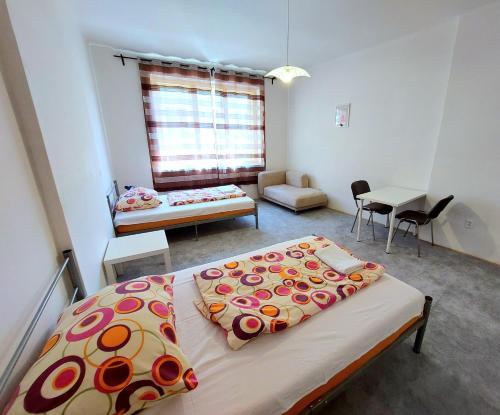 a bedroom with a bed and a living room at Bonvolon in Prague