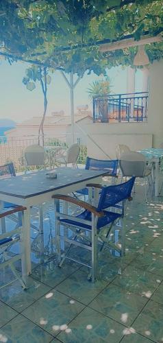 a table and chairs in a patio with a table at Steven in Vasiliki