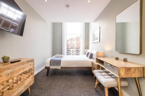 a bedroom with a bed and a large window at Host & Stay - The Georgian Quarters at Canning in Liverpool
