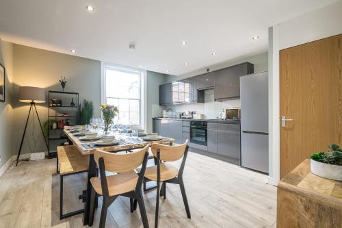 a kitchen and dining room with a table and chairs at Host & Stay - The Georgian Quarters at Canning in Liverpool