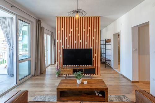 a living room with a flat screen tv on a wall at HOT TUB Sea View SPA in Hvar