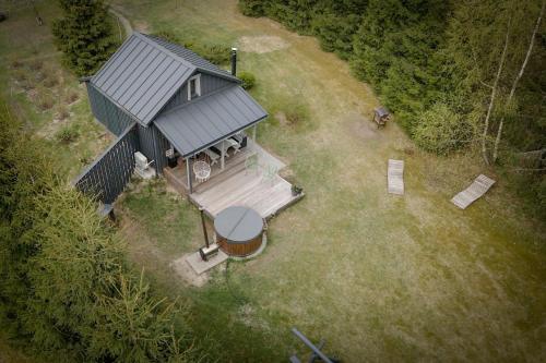 an overhead view of a tiny house with a porch at Gilė -'Virš Ąžuolų' - Forest SPA - Horses - Lake - Chalet in Paplatelė