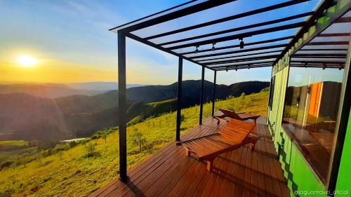a wooden deck with benches on top of a mountain at Refúgio Eco Boutique Tuiuva in Cristina