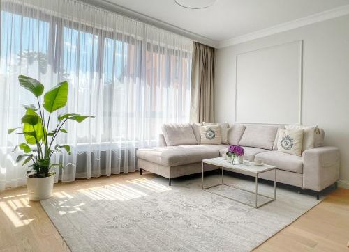 a living room with a couch and a table at Kurkowa Apartments in Szczecin