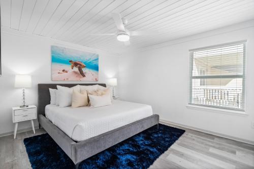 a white bedroom with a bed and a window at Sandpiper Villas Condo 5 in Panama City Beach