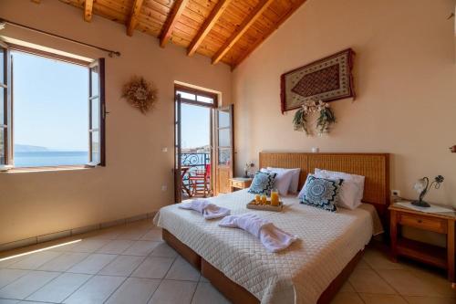 a bedroom with a bed with a view of the ocean at Villa Leleka in Halki