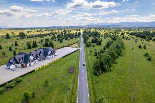 an aerial view of a road next to a house at Hotel Perła Dunajca in Czarny Dunajec