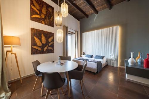 a living room with a table and a bed at Residenza Nausicaa - 50 meters from the beach in Pizzo