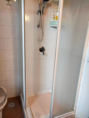 a shower with a glass door in a bathroom at vista sulla vallata in Pitigliano