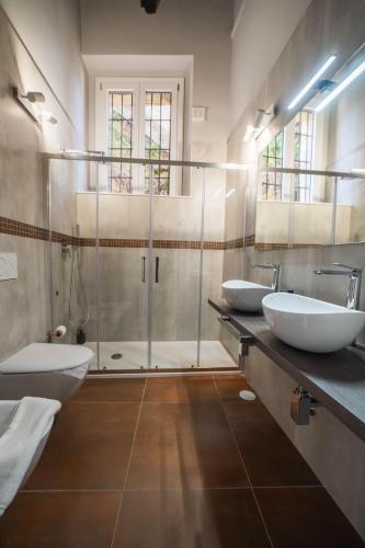 a bathroom with two sinks and a shower at Residenza Nausicaa - 50 meters from the beach in Pizzo