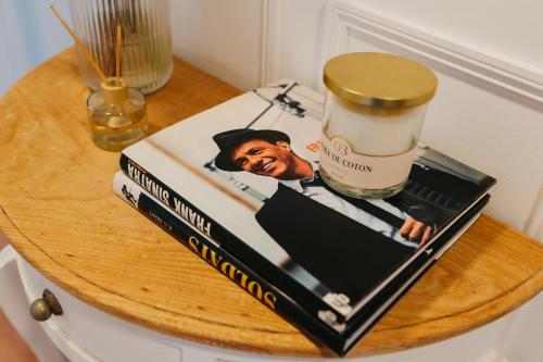 a book on top of a table with a bottle of alcohol at Villa Rafa in Costa Nova