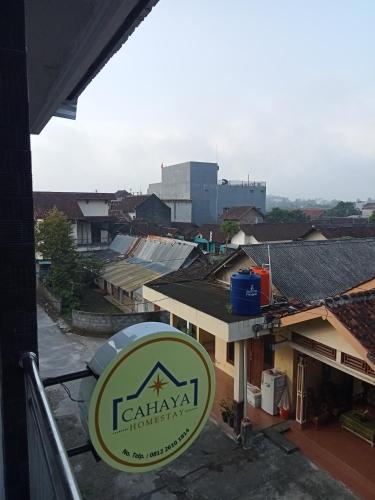 a sign for a restaurant with a view of a city at Cahaya Homestay in Magelang