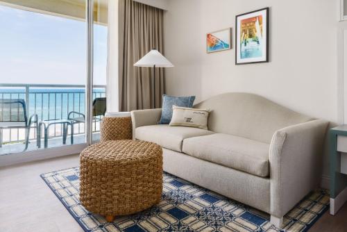 a living room with a couch and a chair at Holiday Inn Resort Lumina on Wrightsville Beach by IHG in Wrightsville Beach