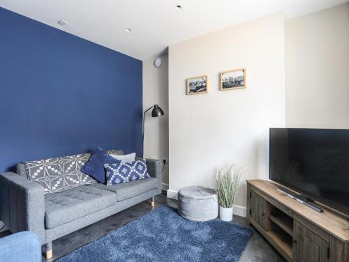 a living room with a couch and a flat screen tv at Nantlle in Caernarfon