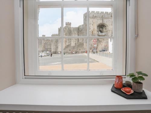 a window with a view of a castle at Nantlle in Caernarfon
