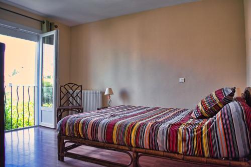 una camera da letto con un letto con una coperta colorata di Agréable maison 3 chambres avec piscine a Carcassonne