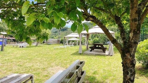 a picnic table and a gazebo in a park at Hotel Avelina in Cangas de Onís