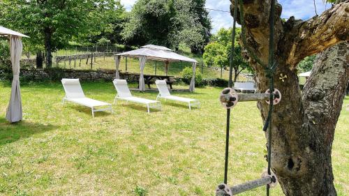 a group of chairs and a tent in a field at Hotel Avelina in Cangas de Onís
