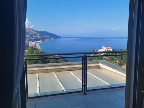 a view of the ocean from a balcony at Taormina Helas Apartment by Taormina Holidays in Taormina