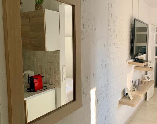 a bathroom with a mirror and a white brick wall at La casa di mare in Agios Gordios