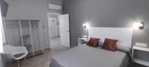 a bedroom with a bed and a desk and a chair at Apartamentos Las trece llaves Jacuzzi bajo reserva in Merida
