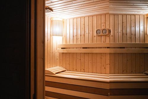 a wooden sauna with a bench in it at Zagroda Nad Kotelnią in Pawłowa