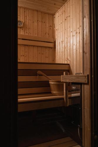 a sauna with a tub in a wooden wall at Zagroda Nad Kotelnią in Pawłowa