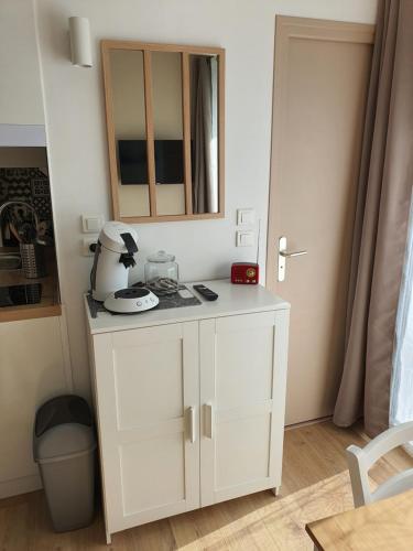 une armoire blanche avec un mixeur dans une pièce dans l'établissement Studio lumineux au calme, vue sur le parc, à Gréoux-les-Bains