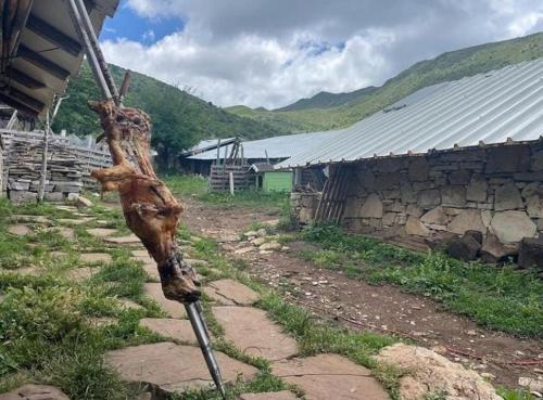 a pole in a field next to a building at Camping Cajupi in Gjirokastër